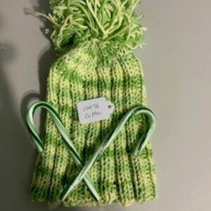 Green crocheted hat with pompom